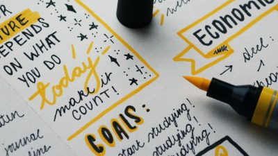 Image: notepad with black and yellow writing