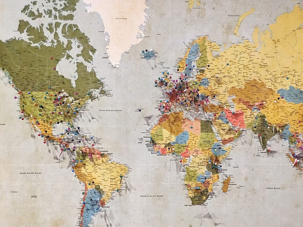 The map of the world with a couple of pins stuck in particular places that the owner must have visited.