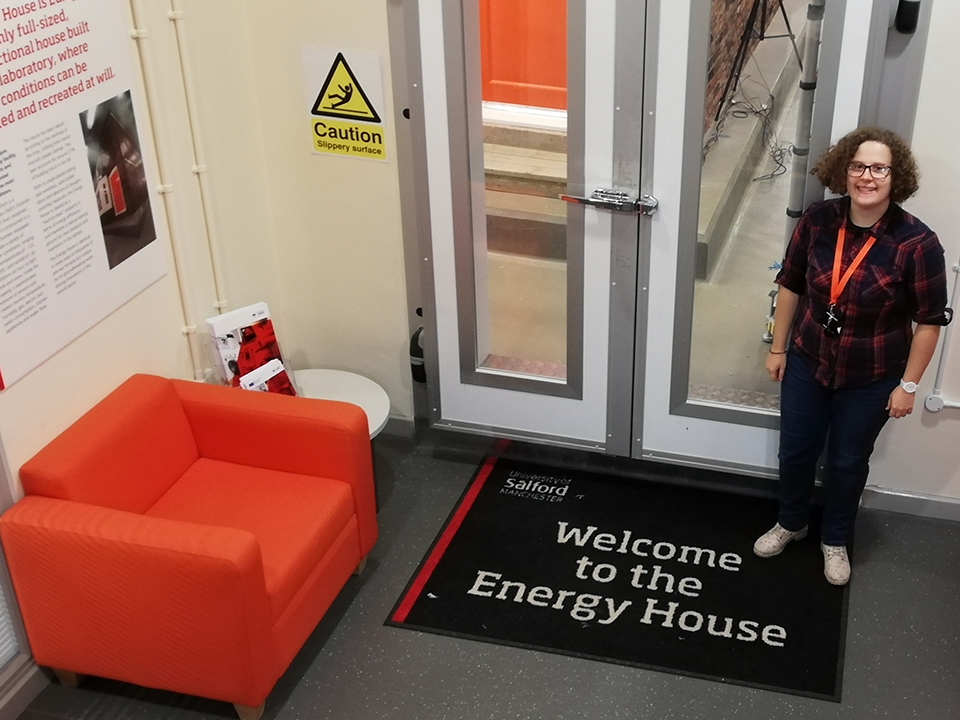 Placement student stood by the doors to Energy House