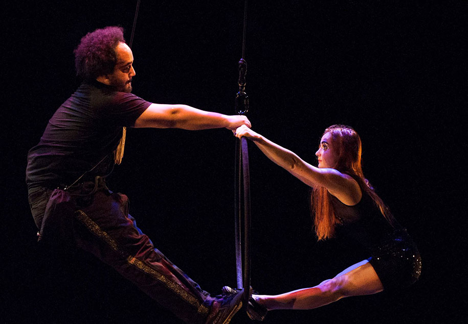 Hovering in the air, the duo both hold onto the hoop with their feet placed on the bottom of the hoop. Bruno on the left and Sandy on the right.