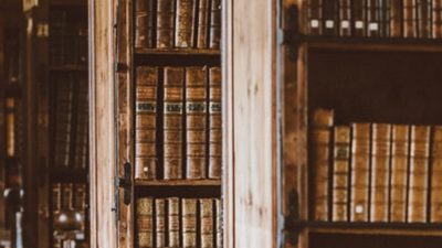Photo of books arranged in an order on a rack