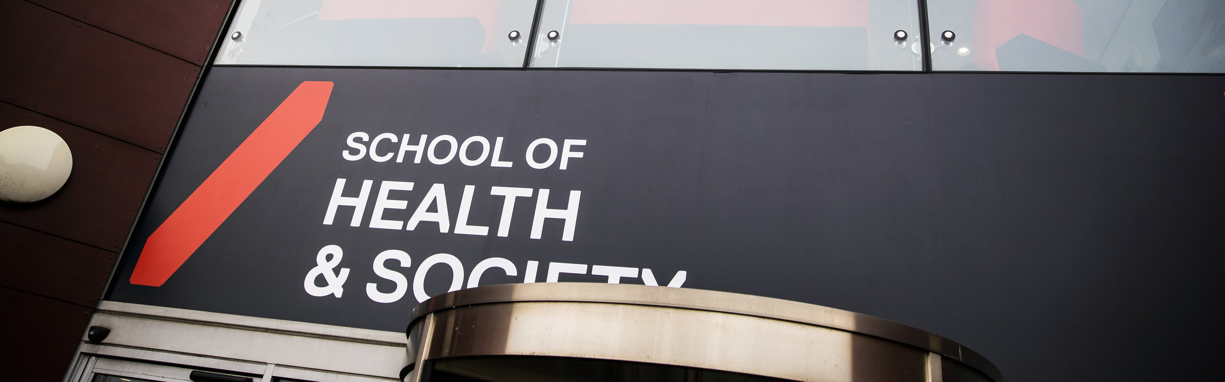 Photo of Health and Society banner infront of mary seacole building
