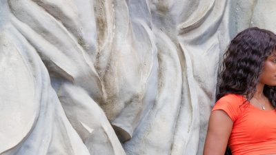 Photo of Natacha leaning against the Engles' beard Statue