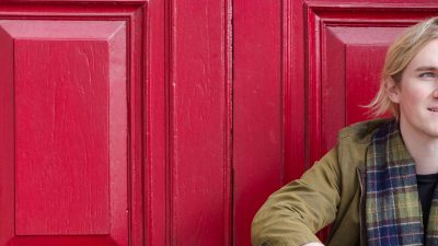 Photo of Tim infront of a red door