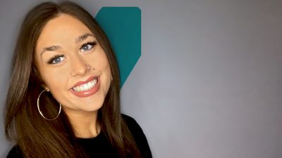 Megan smiling in front of a white background