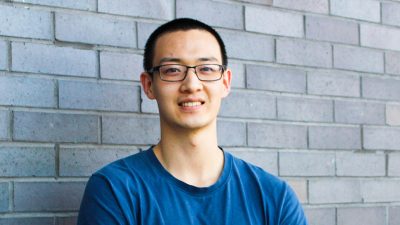 Phoot of Li wearing a blue shirt smiling