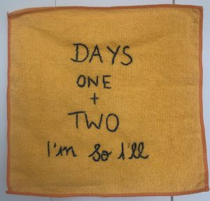 A yellow fibrecloth reading "Days one and two, I'm so ill."