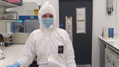 Photo of Holly Broadhurst fully covered with protective suits, masks and gloves