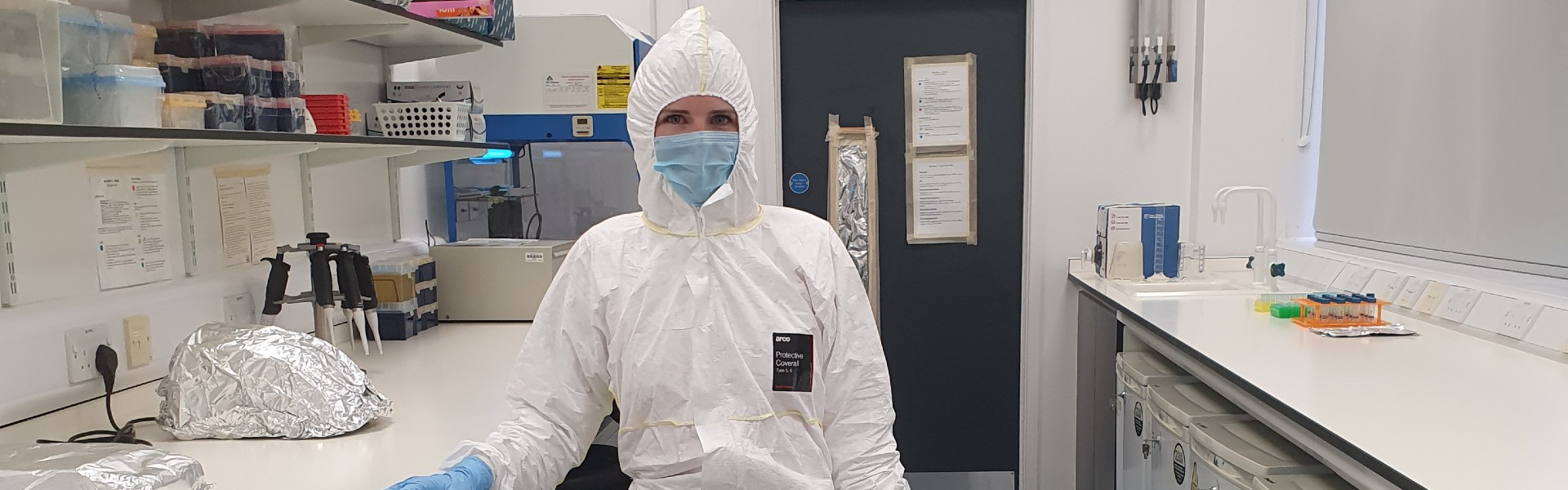Photo of Holly Broadhurst fully covered with protective suits, masks and gloves