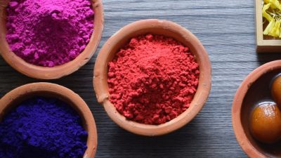 Gulal powders and Indian sweets ready for Holi.