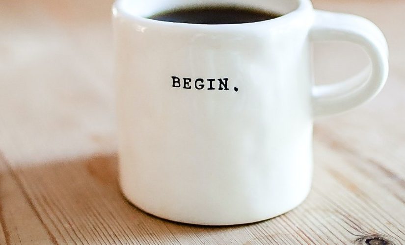 Image of a coffee mug with the word "begin" printed on it