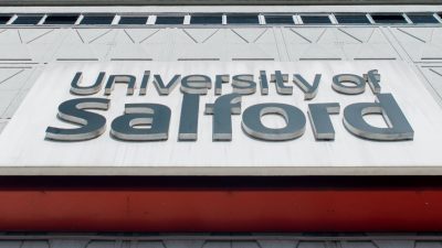 Close up photograph of the University of Salford sign on Maxwell Building