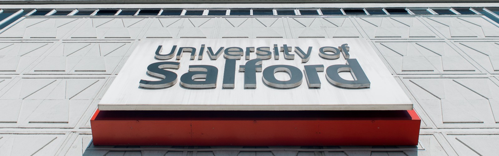 Close up photograph of the University of Salford sign on Maxwell Building