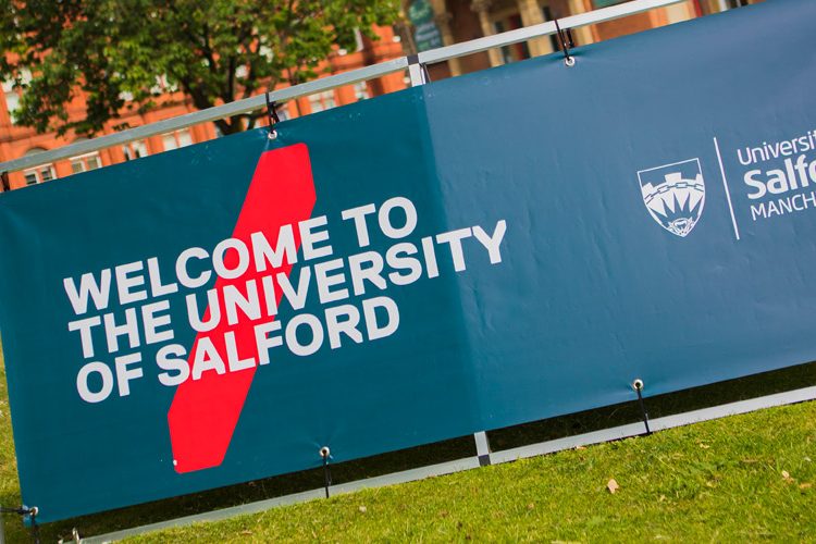 Photo of Uni of Salford Welcome Banner infront of Maxwell Building
