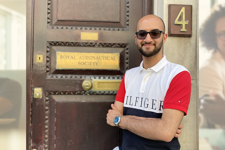 photo of Abdul standing next to the Royal Aeronautical Society door