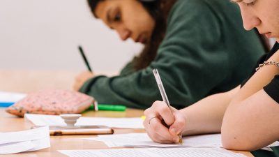 Two students writing in exam