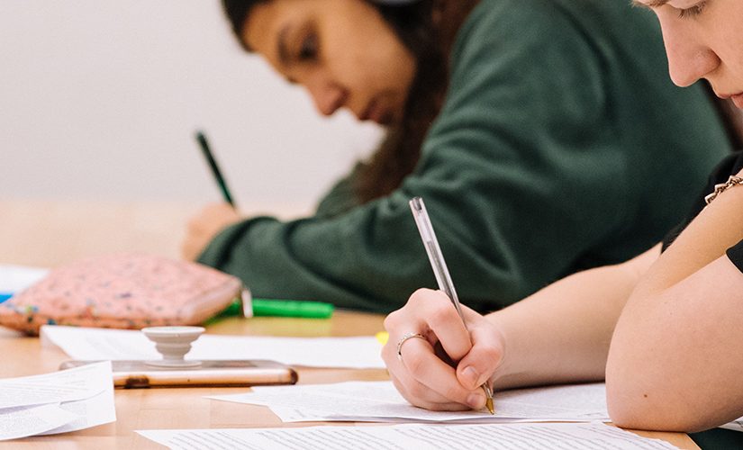 Two students writing in exam