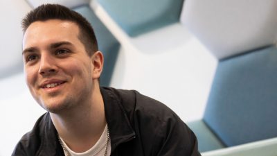 Photo of Sam wearing a Black shirt smiling