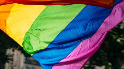 People holding the LGBTQ Flag