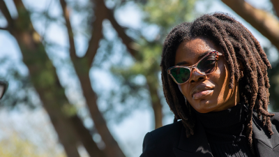 Photo of a women with glasses talking to a man on the other side