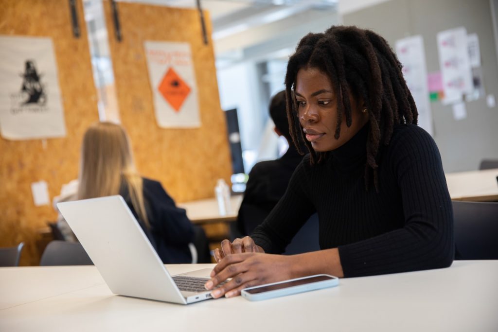 photo of Chidera Stephen working on her laptop