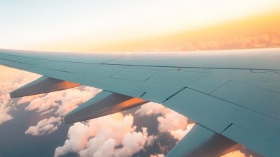 Photo of a plane's wing out of the window of a plane