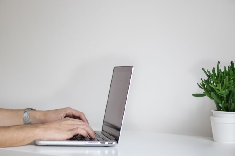 Student typing on a laptop. 