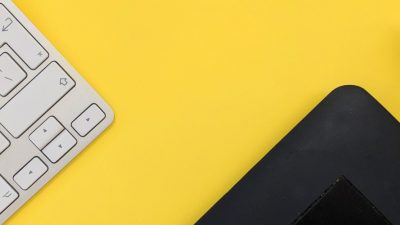 Image of a keyboard, stylus and edge of an electronic tablet