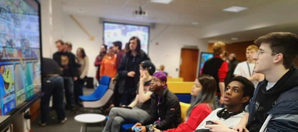 Salford Gaming Society playing a video game together in University House.