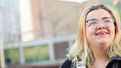 A photo of Ellie sat outside of Chapman Building