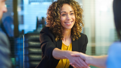 An interview candidate shaking hands with a member of the interview panel