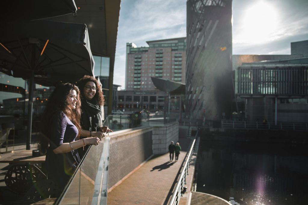 Photo of two students overlooking Salford Quays