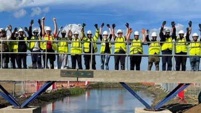 Students on a bridge at construction site at constructionarium