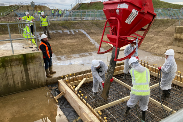 Constructionarium students working in a group and using a specialist equipment on site