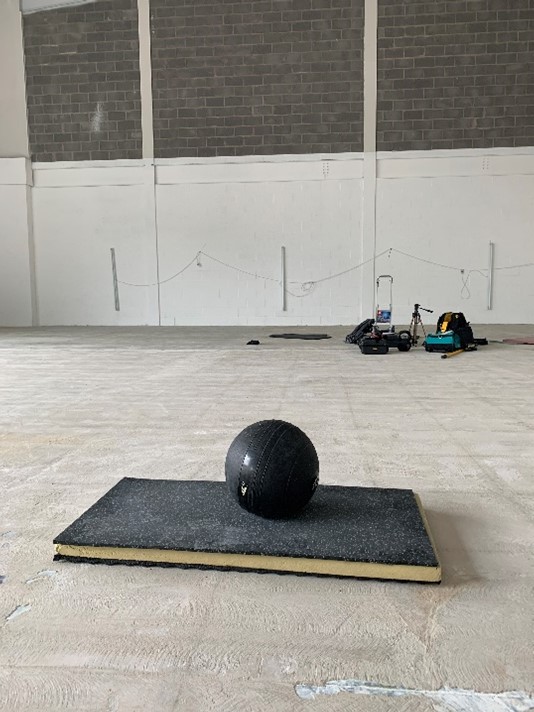 Image of testing sound equipment in an fairly empty room