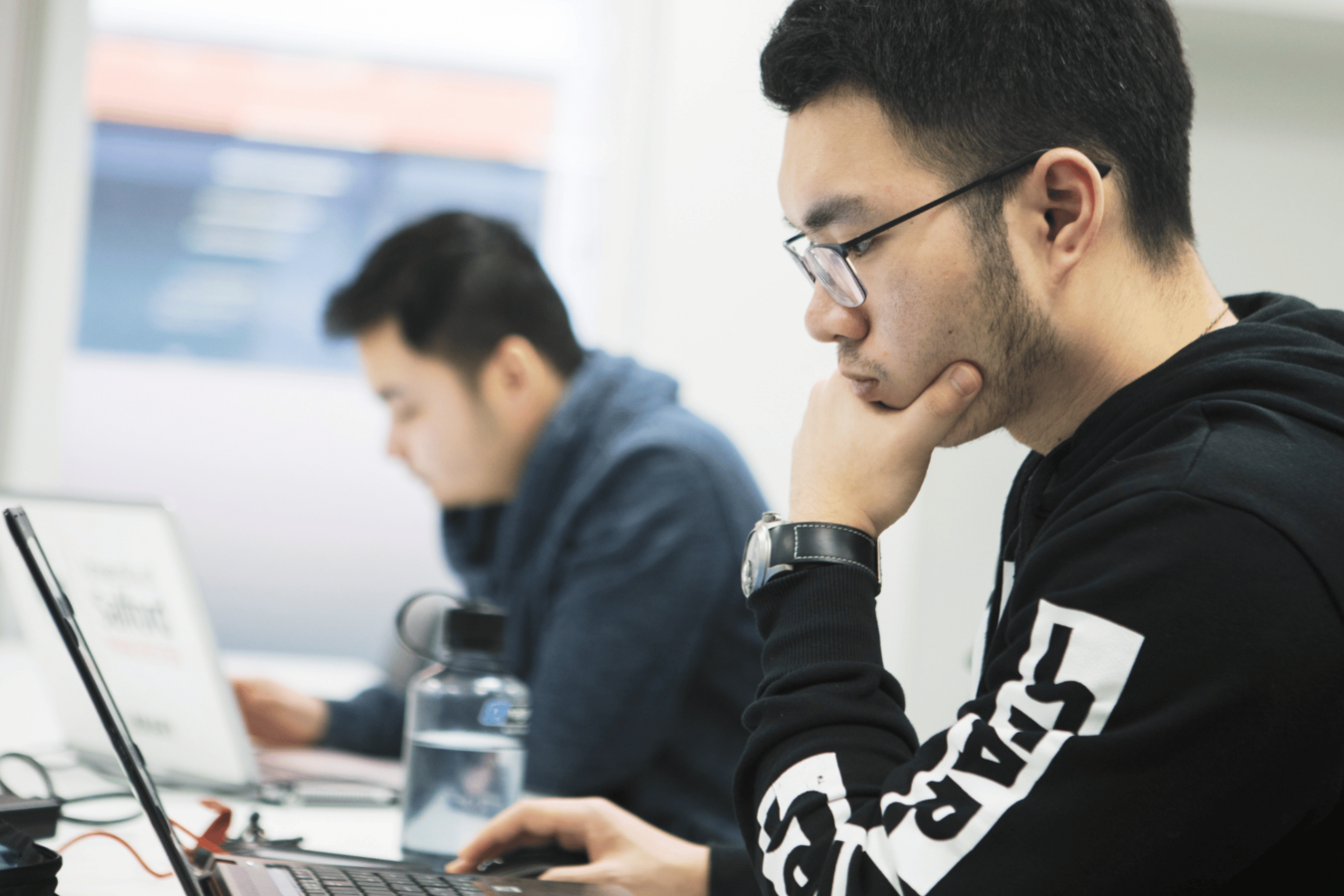 Two students on their laptops