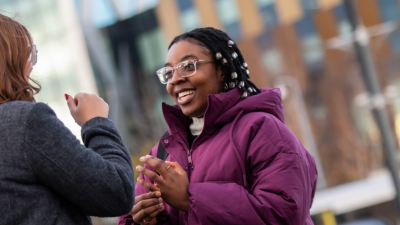 Two students chatting at Salford Quays