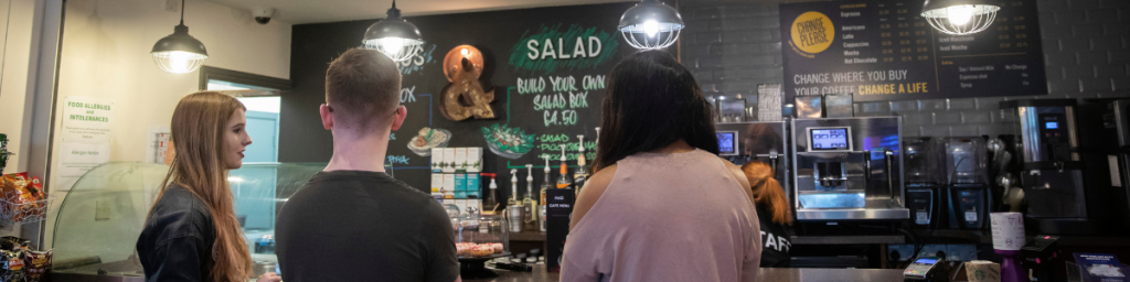 Three Students ordering coffee.