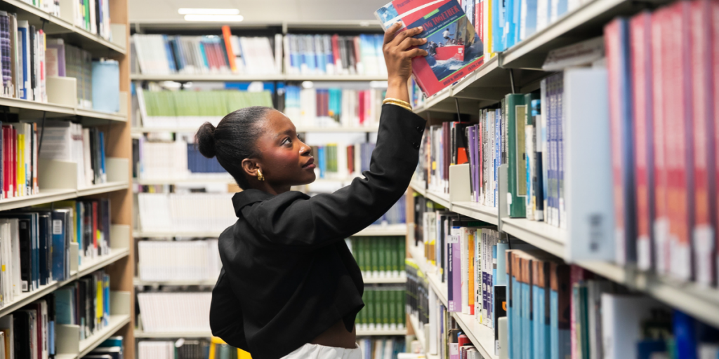 Student browsing the books in the library