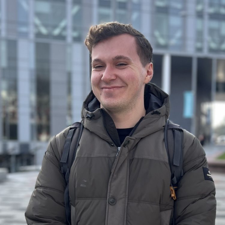 James Donaldson smiling in front of the New Adelphi building.