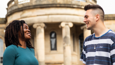 Two students are talking to each other on Chapel Street.