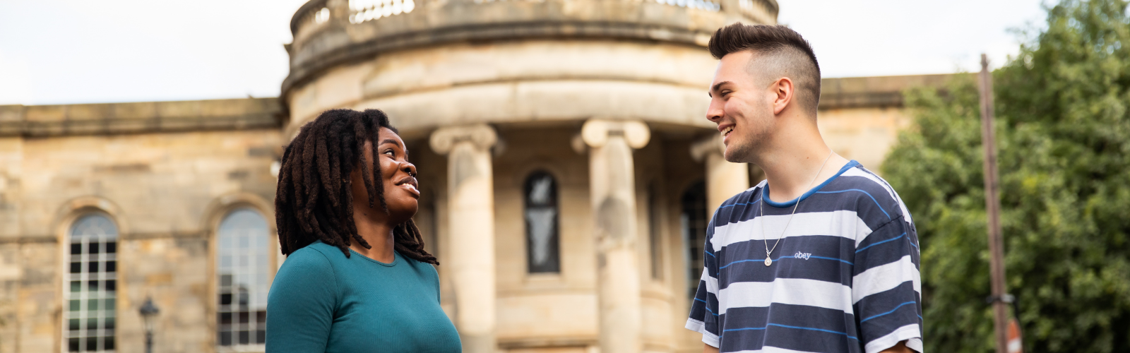 Two students are talking to each other on Chapel Street.