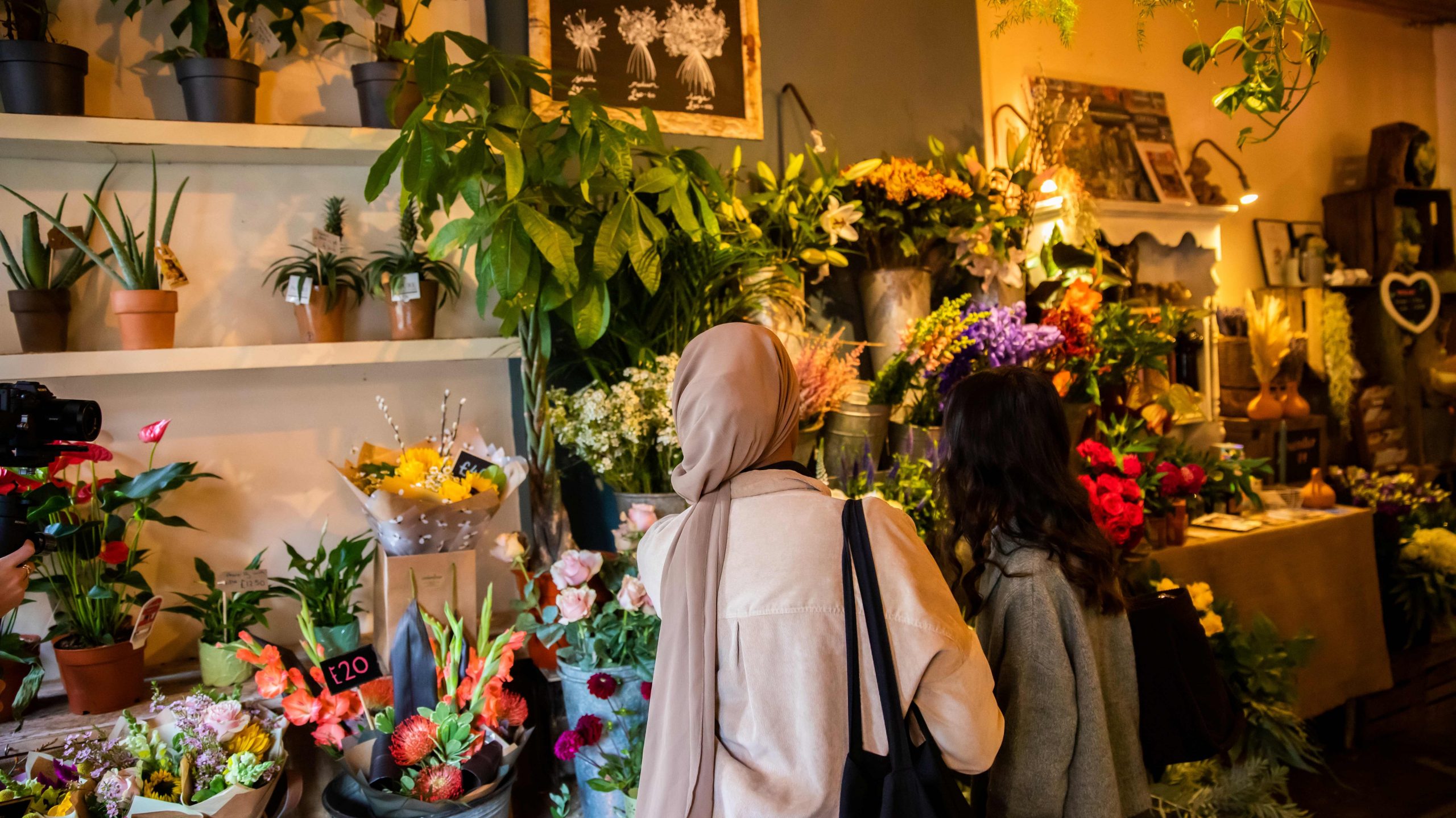 Two students looking at flowers in Manchester