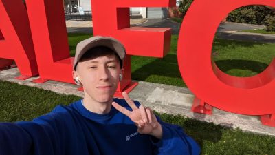 A selfie of Josh next to the SALFORD sign