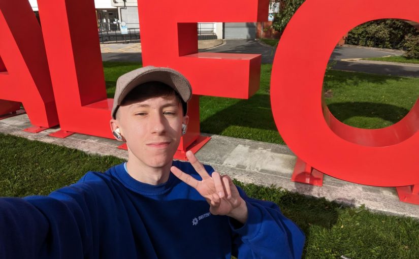 A selfie of Josh next to the SALFORD sign