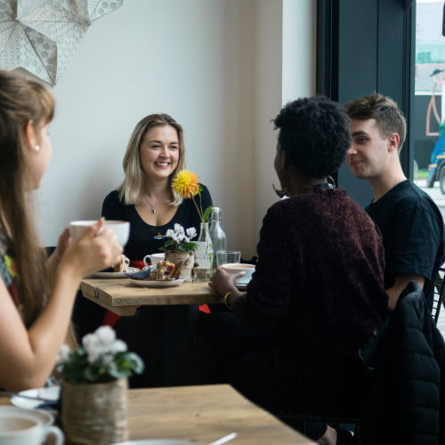 Friends talking at a cafe