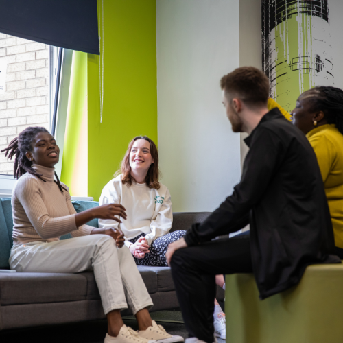 Four students chatting in accommodation.