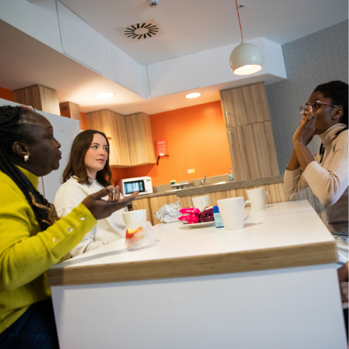 Students talking at a table in student accommodation