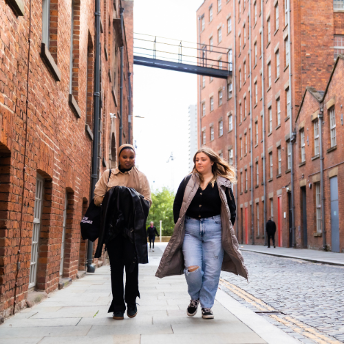 Two students walking in Manchester