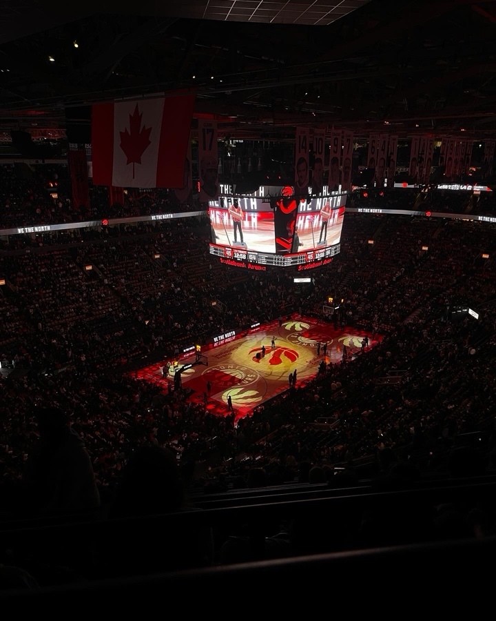 A dark image of a sports court with screens